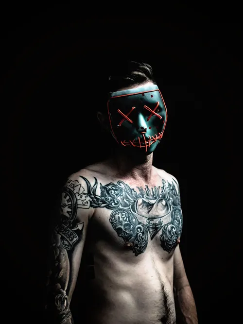 Tattooed man with mask